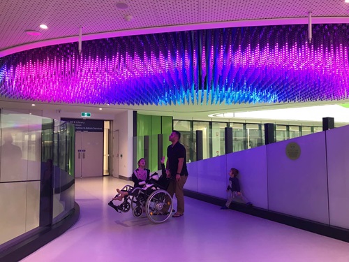 Ayla in a wheelchair underneath 'Surface' at PCH