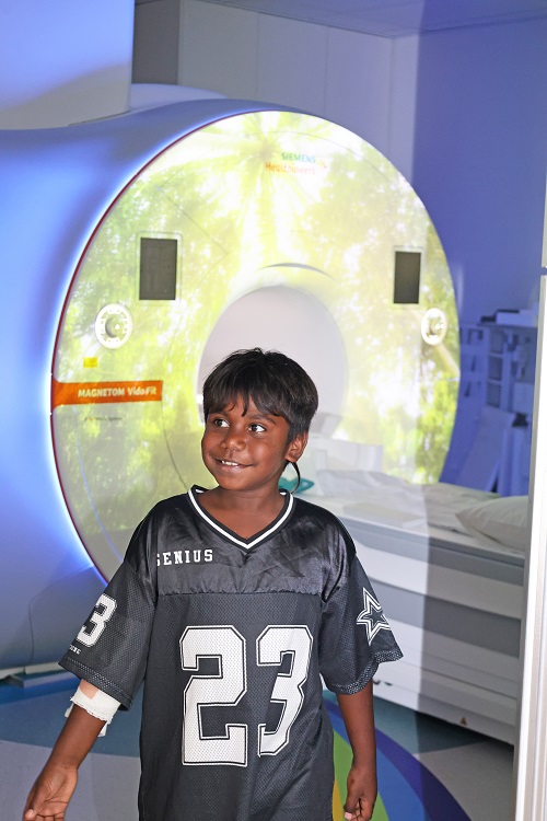 7-year-old Vinnique pictured with the new MRI at Perth Children's Hospital