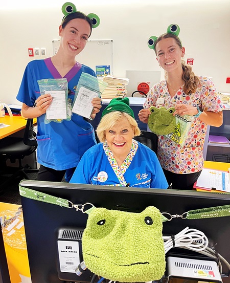 A group of PCH Cystic Fibrosis nurses and allied health staff holding the new CF Frog merchandise, coinciding with the leap year sputum collection passport challenge